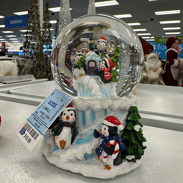 Snow globe with penguins playing in a holiday setting found in Ross Dress for Less.