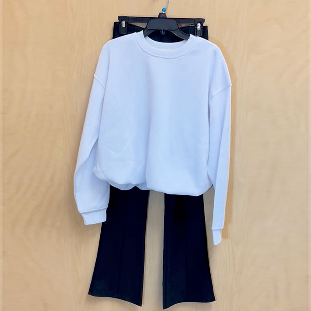 Black flare yoga pants with a white bubble hem sweatshirt from a Ross store.