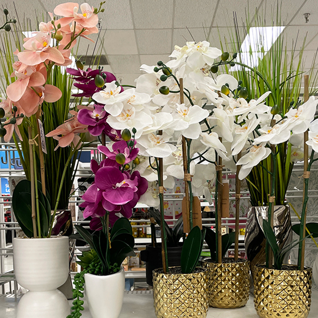 Faux white and purple orchids in white and gold colored planter pots found in store at Ross.